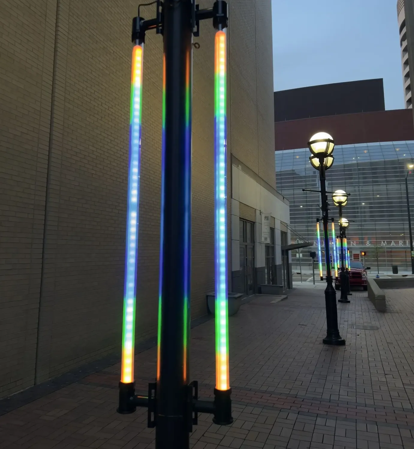 Pole-mounted addressable LED light tubes lit on a downtown light pole