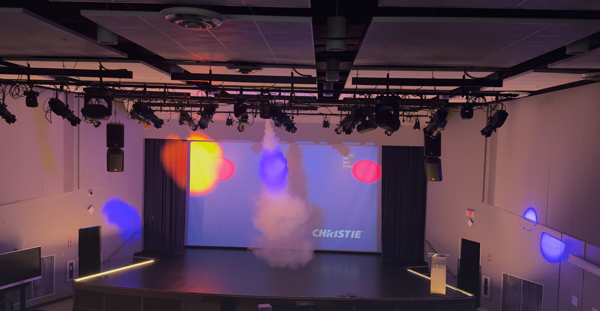 Projection and custom lighting display in a venue