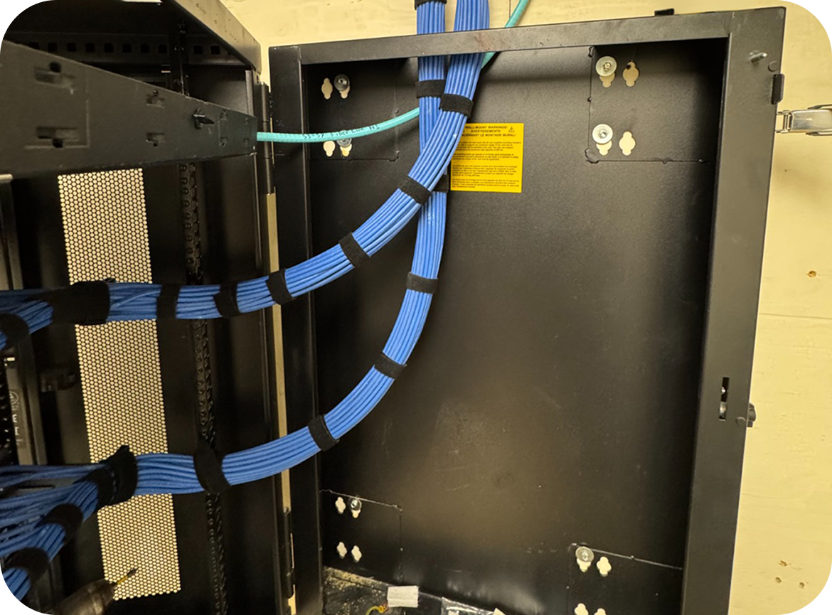 Structured cabling dressed and routed inside a wall to the network closet